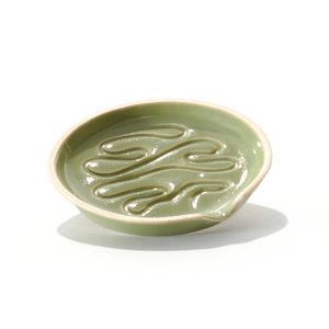 Millie is a ceramic grinder tray that grinds weed and funnels cannabis into a pipe bowl, this smoke accessory is handmade by a woman-owned studio in the USA. Millie in moss green  is a ceramic grinder that grinds cannabis, easily funnels weed into a pipe or bong bowl, is easy to clean and keeps your hands mess free. 