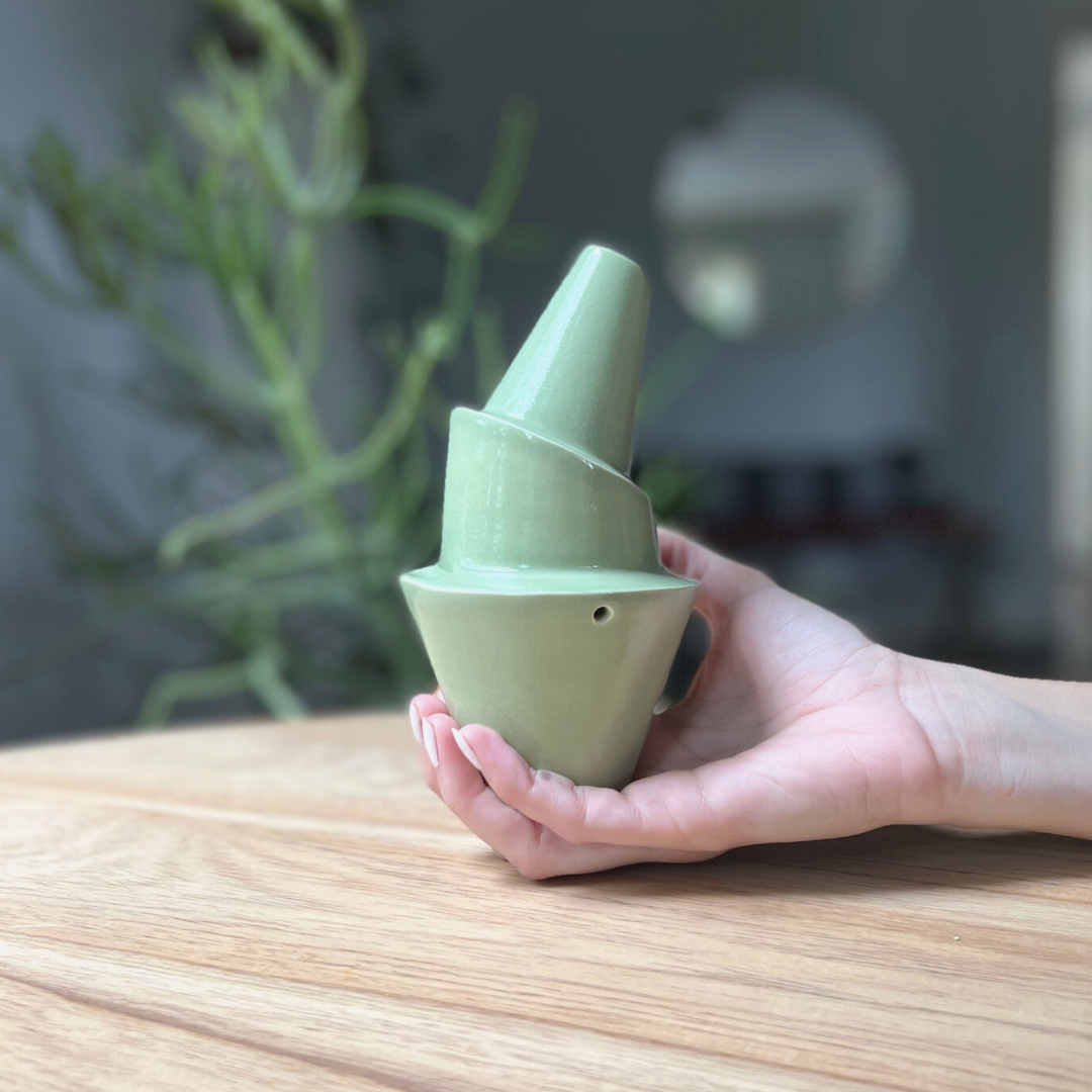 A ceramic bubbler that smokes like a dream and complements interior design; this water pipe, or mini bong, is handmade by a woman-owned studio in the United States. Billie is a green ceramic water pipe that doubles as art in your home and pairs well with your favorite smoke accessories. Smoke your favorite bud from this ceramic bong in moss.