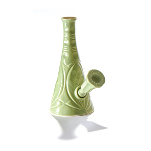 A ceramic bong that smokes like a dream and complements interior design; this water pipe is handmade by a woman-owned studio in Missouri, USA. Flora is a green ceramic water pipe that doubles as art in your home and pairs well with your favorite smoke accessories. Smoke your favorite bud from this ceramic bong in Moss.
