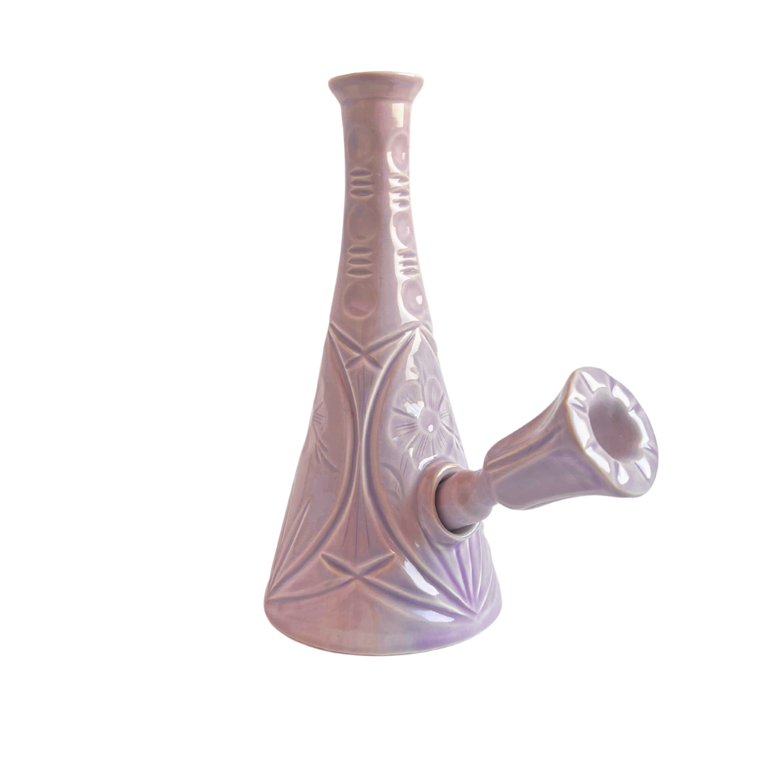 A ceramic bong that smokes like a dream and complements interior design; this water pipe is handmade by a woman-owned studio in the USA. Flora is a purple ceramic water pipe that doubles as art in your home and pairs well with your favorite smoke accessories. Smoke your favorite bud from this ceramic bong in Lilac.