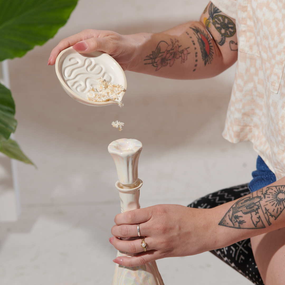 Millie in Pearl is a ceramic grinder tray that grinds weed and funnels cannabis into a pipe bowl, this smoke accessory is handmade by a woman-owned studio in the USA. Millie in pearl  is a ceramic grinder that grinds cannabis and is a great weed accessory to use while enjoying your favorite b