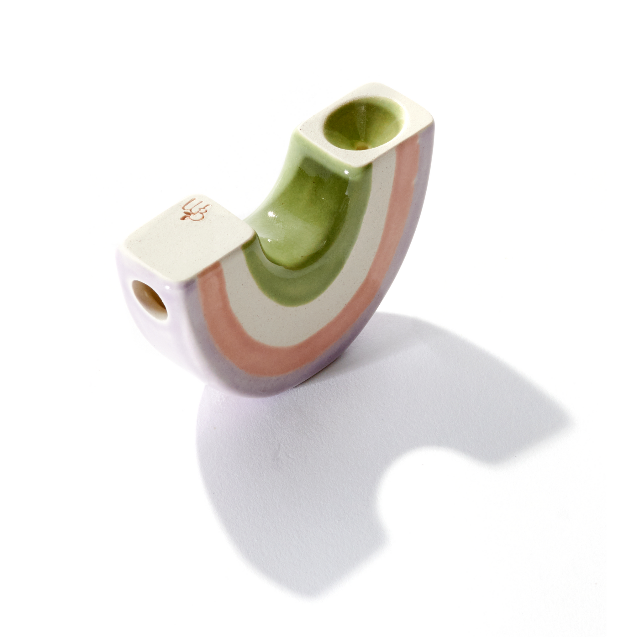 A ceramic rainbow-shaped pipe that smokes like a dream and feels great in the hand, this hand pipe is handmade by a woman-owned studio in the USA. Rainbow pipe is green, purple, beige pink colored ceramic pipe that pairs well with your favorite smoke accessories. Smoke your favorite bud from this ceramic dry pipe. 