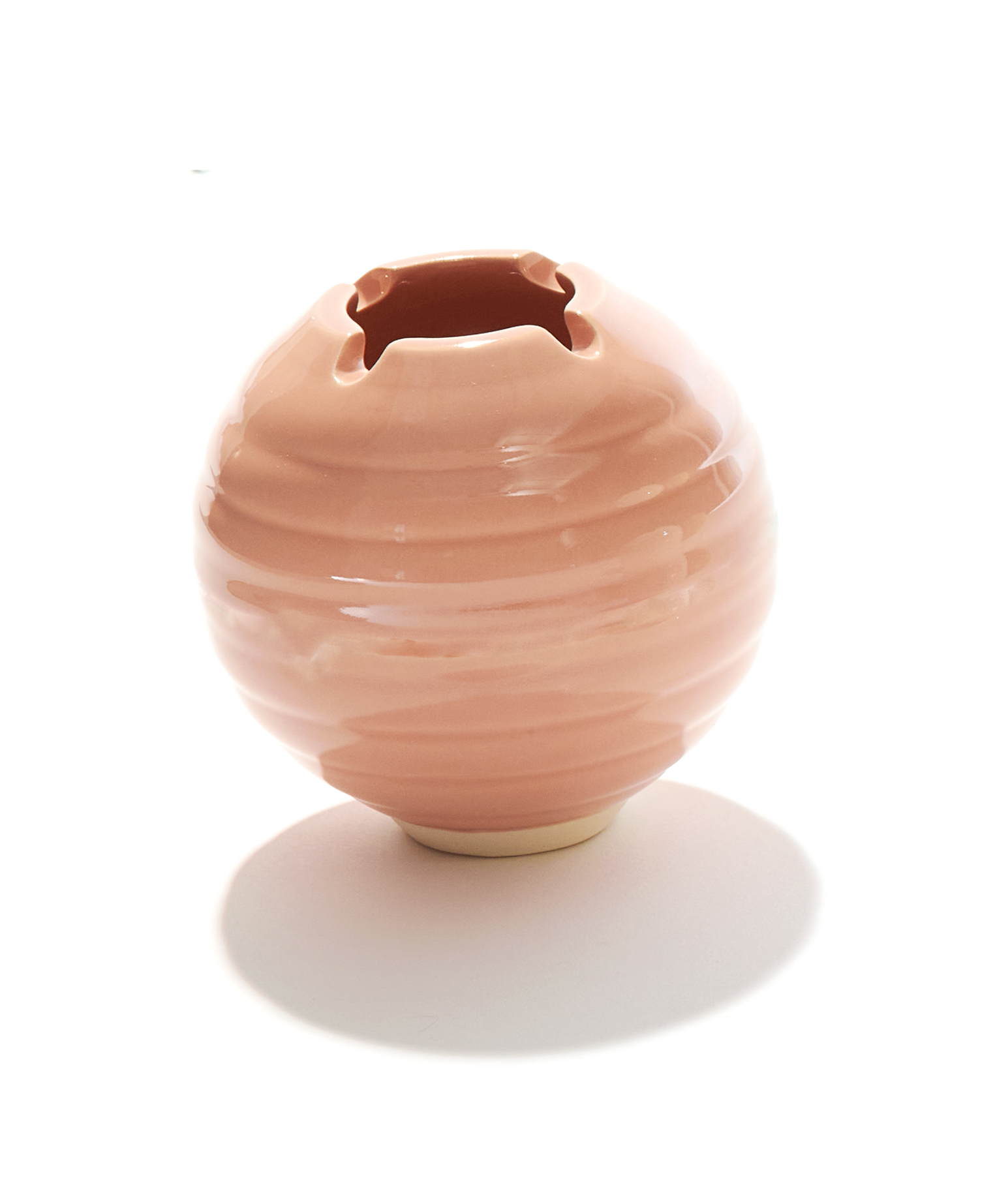 A ceramic ashtray that features a poker and a lid, this cannabis accessory is handmade by a woman-owned studio in the USA. The Orb in beige pink comfortably fits in your hand and doubles as art in your home with secure fit lid. The Orb ashtray is a discreet weed accessory to use while using your favorite bud products.
