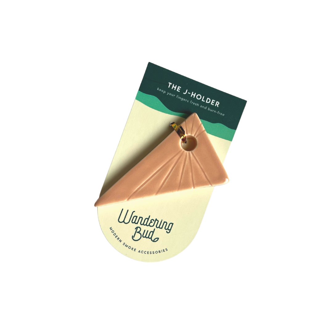 Our Triangle Jay Holder is the perfect cannabis accessory made to keep your fingers fresh and away from the flame. This triangle joint holder in beige is handmade in a woman-owned studio in the USA. This hand rolled holder in pink is great cannabis weed accessory to accompany your smoke sesh of you favorite bud.