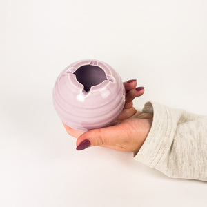 A ceramic ashtray that features a poker and a lid, this cannabis accessory is handmade by a woman-owned studio in the USA. The Orb in purple comfortably fits in your hand and doubles as art in your home with a secure fit lid. The ashtray is a discreet cannabis accessory to use while using your favorite bud products.